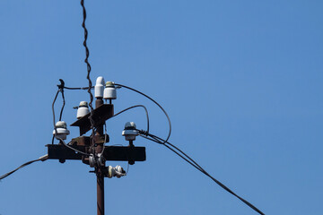 An old house electrical substation. Electricity lines to residents' homes. The equipment still uses old technology. Made of iron and white ceramic