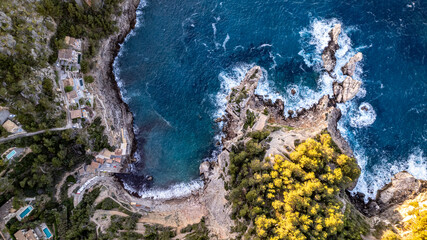drone aerial view sunset over rocky hill in Deia in Mallorca on a hot summer day