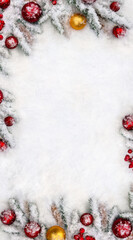 Christmas decoration. Christmas tree, spruce cones, red and yellow balls, red berries on snow with space for text. Top view, flat lay