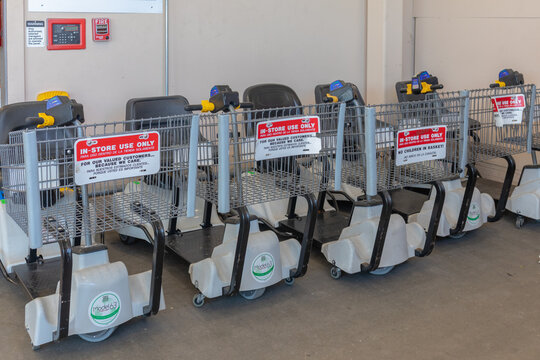 Several EVC, electric scooter shopping carts at retail store, lined up for disabled customer use. Kissimmee, Fl. 4-4-24