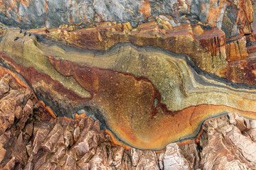 Natural rock texture of a colorful rock formations in silence beach (playa del Silencio) in Asturias, north of Spain.