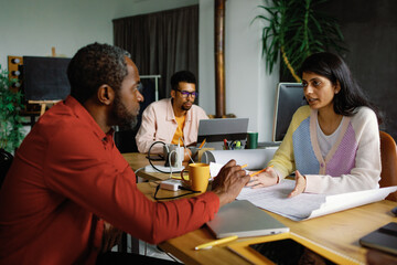 Three colleagues meeting. Creative office workers dialogue