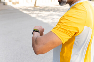 Man checking smartwatch during outdoor workout session