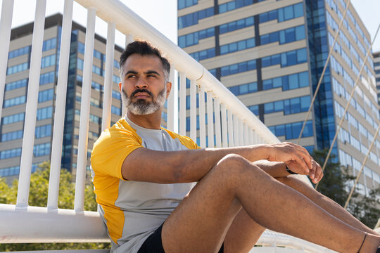 Indian man resting after sport session in summer - Powered by Adobe