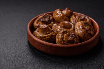 Delicious juicy whole champignons baked on the grill with salt and spices