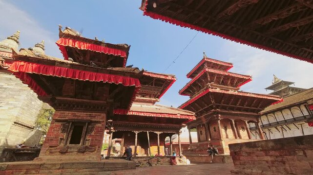 Bhaktapur, Nepal - 6th january, 2024: panorama time lapse tourist visit famous sunny Durbar Square - historically and culturally significant site in Kathmandu, Nepal. Unesco world heritage site