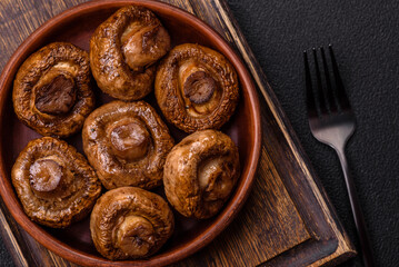 Delicious juicy whole champignons baked on the grill with salt and spices