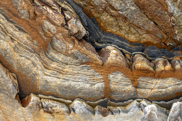 Natural rock texture of a colorful rock formations in silence beach (playa del Silencio) in Asturias, north of Spain.