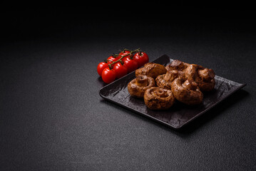 Delicious juicy whole champignons baked on the grill with salt and spices