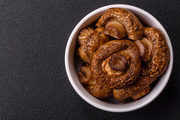 Delicious juicy whole champignons baked on the grill with salt and spices
