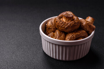 Delicious juicy whole champignons baked on the grill with salt and spices