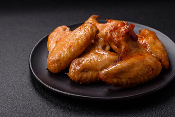 Delicious fried chicken wings with salt, spices and herbs