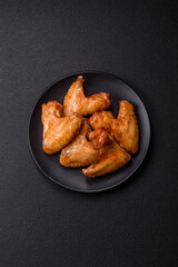 Delicious fried chicken wings with salt, spices and herbs