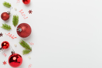 Christmas balls on color background, top view