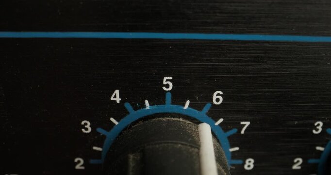 A man adjusts a vocal compressor in a recording studio. Close-up of his hand, an unrecognizable person
