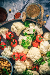Ingredients vegetarian dish cauliflower baked chickpeas tomatoes