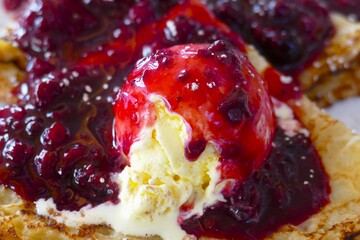 Pancake with vanilla ice cream and blueberry sauce