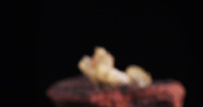 Yellow Adamite crystals cluster mooving footage. isolated on black background. macro detail close-up mineral crystal unpolished semi-precious gemstone.