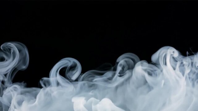 Smoke effect rises from bottom against black background with copy space at top. White mist, fog overlay