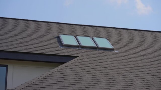 A new roof with skylight is installed on a private house