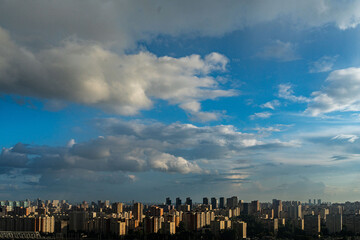 Panorama of a big city with blue sky and clouds from above. View of the big city from above.Space...