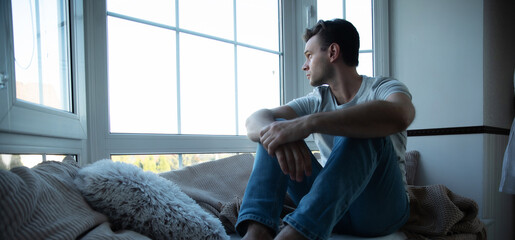 Depressed, sad, frustrated, crying, scared, instability mental and bipolar young man sitting on the...