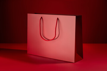 Red paper shopping bags mockup with red handles on red background