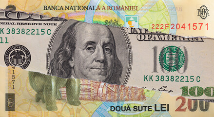 100 dollar banknote through torn 200 Romanian Lei banknote