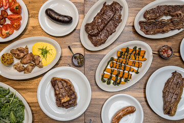 Grilled meat with vegetables to share top view