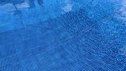 Close-up of Pool Tiles with Rippled Water Reflection, Blue Mosaic Background