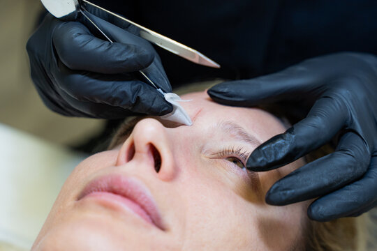 Beautician Performs Microblading Measurements on Client