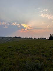 landscape with sun rays and clouds