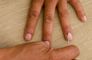 A person is using a cuticle remover file