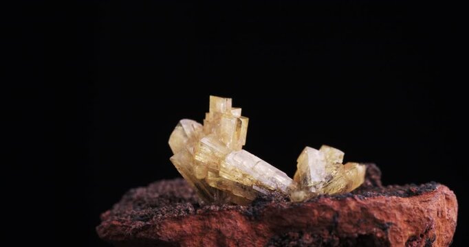 Yellow Adamite crystals cluster 360&deg; rotation footage. isolated on black background. macro detail close-up mineral crystal unpolished semi-precious gemstone.