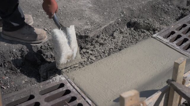 Concrete curb at road construction site. The road is ready Installation of concrete curbs during road construction. Laying Sidewalk Curbs 