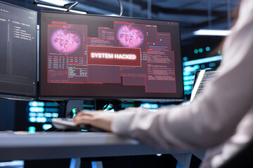 IT professional in server hub trying to protect hardware from hacker stealing information. Worker...