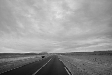Artistic black and white landscape of a road in perspective in the middle of the desert in the...