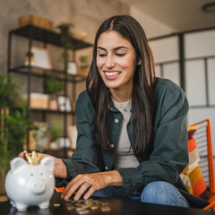 happy adult caucasian woman save money coins in the piggy bank
