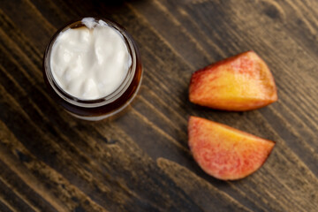 fresh yogurt with jam and pieces of ripe nectarine