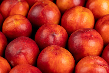 a large number of ripe soft nectarine fruits on the table