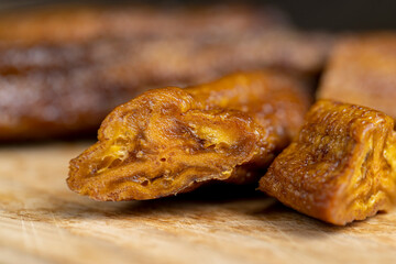 dried small bananas on a wooden board