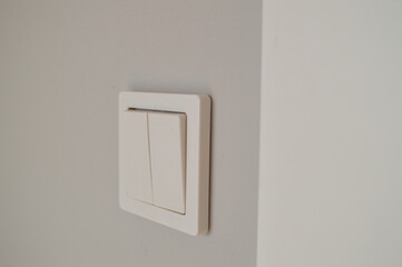 White wall light switch, electricity.