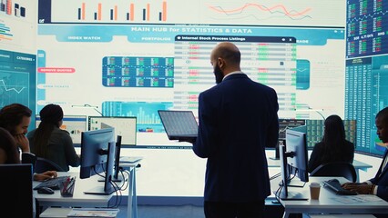 General director employing big data to help in solving tasks in control room, operating on huge...