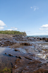 A beautiful view of Split Rock Lighthouse on the rocky coast of Lake Superior.