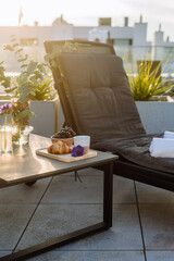 Rooftop terrace with lounge chair and breakfast on table