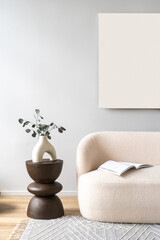 Abstract art, modern white sofa with end table and greenery in room