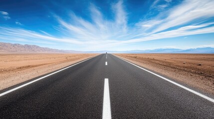 Fototapeta premium An empty road leading towards a bright horizon, symbolizing the path to success.