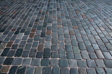 Background of cobblestone. Architecture background with stone cladding road. Concrete tiles background. Stone road background for poster or banner.