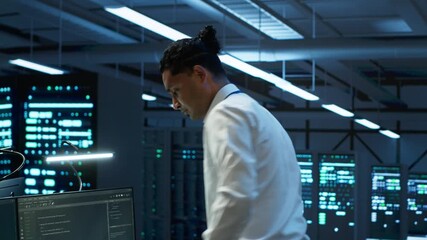 Data center computer scientist responsible for installation of networking equipment solving tasks. Indian man at work doing maintenance on server room infrastructure, camera A - Powered by Adobe