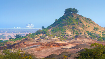 Sir Bani Yas Island, United Arab Emirates - Jan 18 2024, aerial panoramic view of tree-covered mountain, in  background, the MSC Virtuosa cruise ship is moored near the beach, Sir Bani Yas Island, UAE